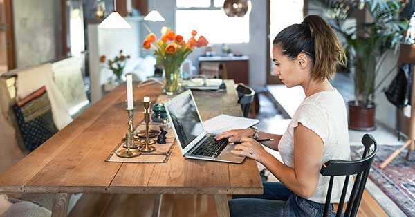 Kvinne sitter på kjøkkenbordet og forbereder seg til visning