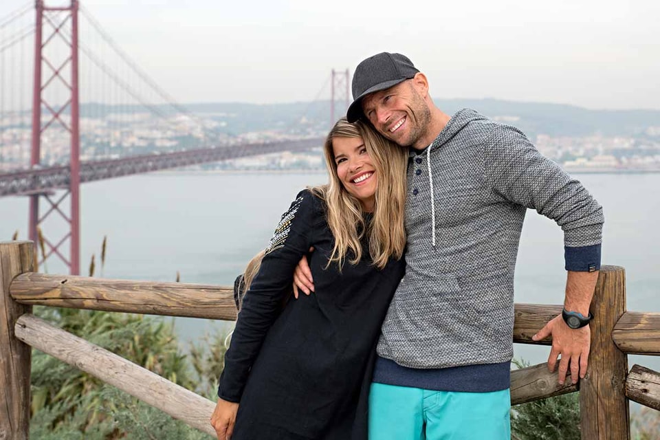 Kvinne og mann gir hverandre en klem på ferie fremfor Golden Bridge, til illustrasjon for sparekonto